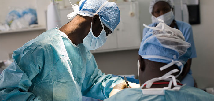 African doctors in a hospital operating on a patient