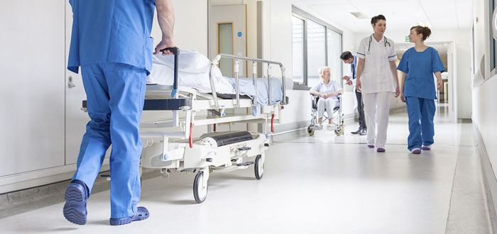 Nurses and patients in a hospital corridor